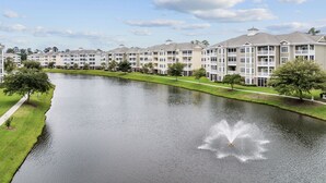 A multi-story residential building with a central courtyard and a fountain.