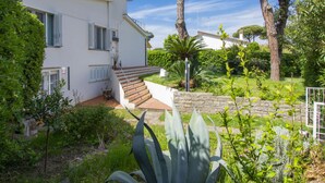 A white two-story house with a staircase leading to a balcony. - Le Dune by Interhome (Tirrenia)