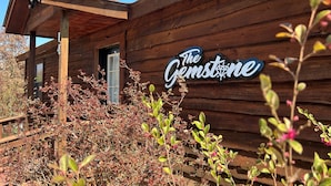 A wooden building with a sign that reads "The Gemstone."