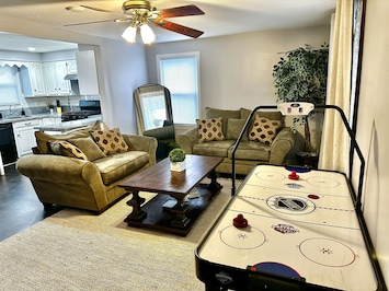 Living room, two comfortable heavy couches, large table, standing mirror