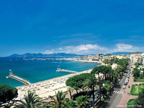 Stroll along the waterfront promenade, lined with palm trees and offering stunning views of the sea.