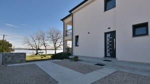 A modern building with a flat roof, a balcony, and a door with a handle. - Sea side by Interhome (Pašman/Kraj)