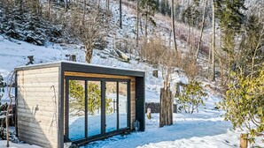 A modern cabin with large windows, surrounded by snow-covered ground and trees. - Charming Mountain Lodge & Wellness by Interhome (Horní Maršov/Pec pod Sněžkou)