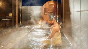 A person in a steam room with a sauna visible in the background. - Ishigaki sen (Beppu)