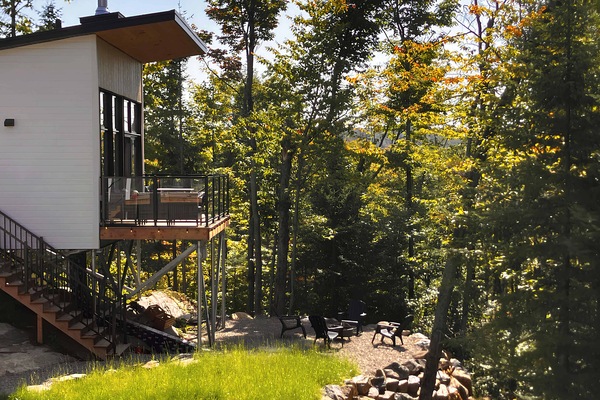Exterior view of the chalet with a wood-burning outdoor fireplace.