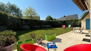 A patio area with outdoor furniture, a small table, and potted plants. - Carnac: 5-room house with garden, 7 people, WiFi, pets allowed (Carnac)
