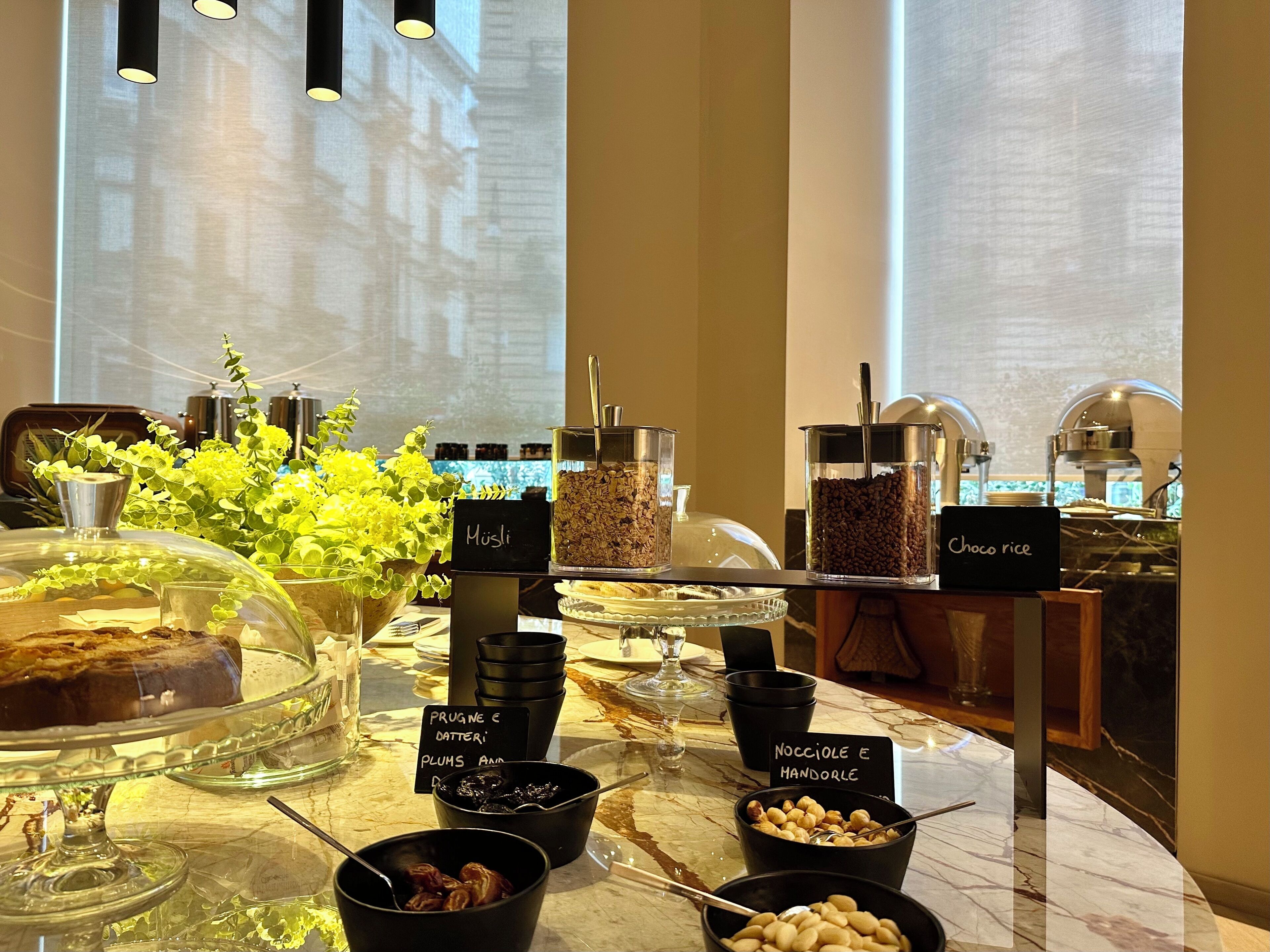 A breakfast buffet with various food items and a coffee station.