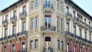 A corner building with multiple balconies, large windows, and a distinct architectural style. - Palazzo Liberty (Palermo)