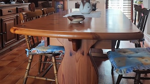A spacious dining area with a large wooden table, several chairs, and a television. - Villa 100 steps from the beach (CIN It092066C2000R5478) (Sardegna)