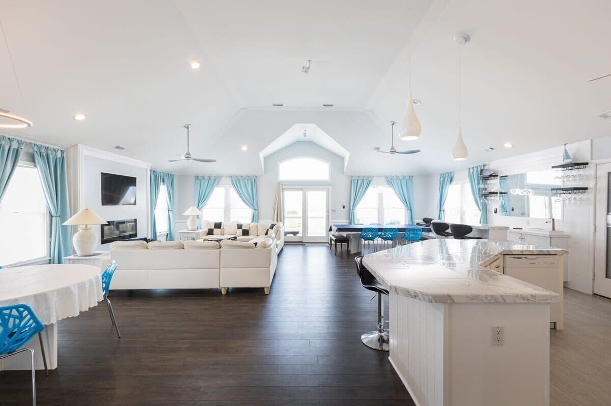 A spacious living area with a sofa, dining table, and kitchen.