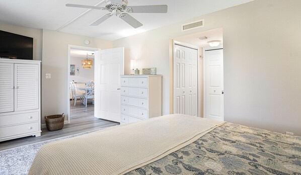A bedroom with a bed, a ceiling fan, a dresser, and a wardrobe. - 🌺Angled View of Gulf!🐬 Loggerhead Cay 592, ***NEW ***Dog Friendly🐶 (Sanibel)
