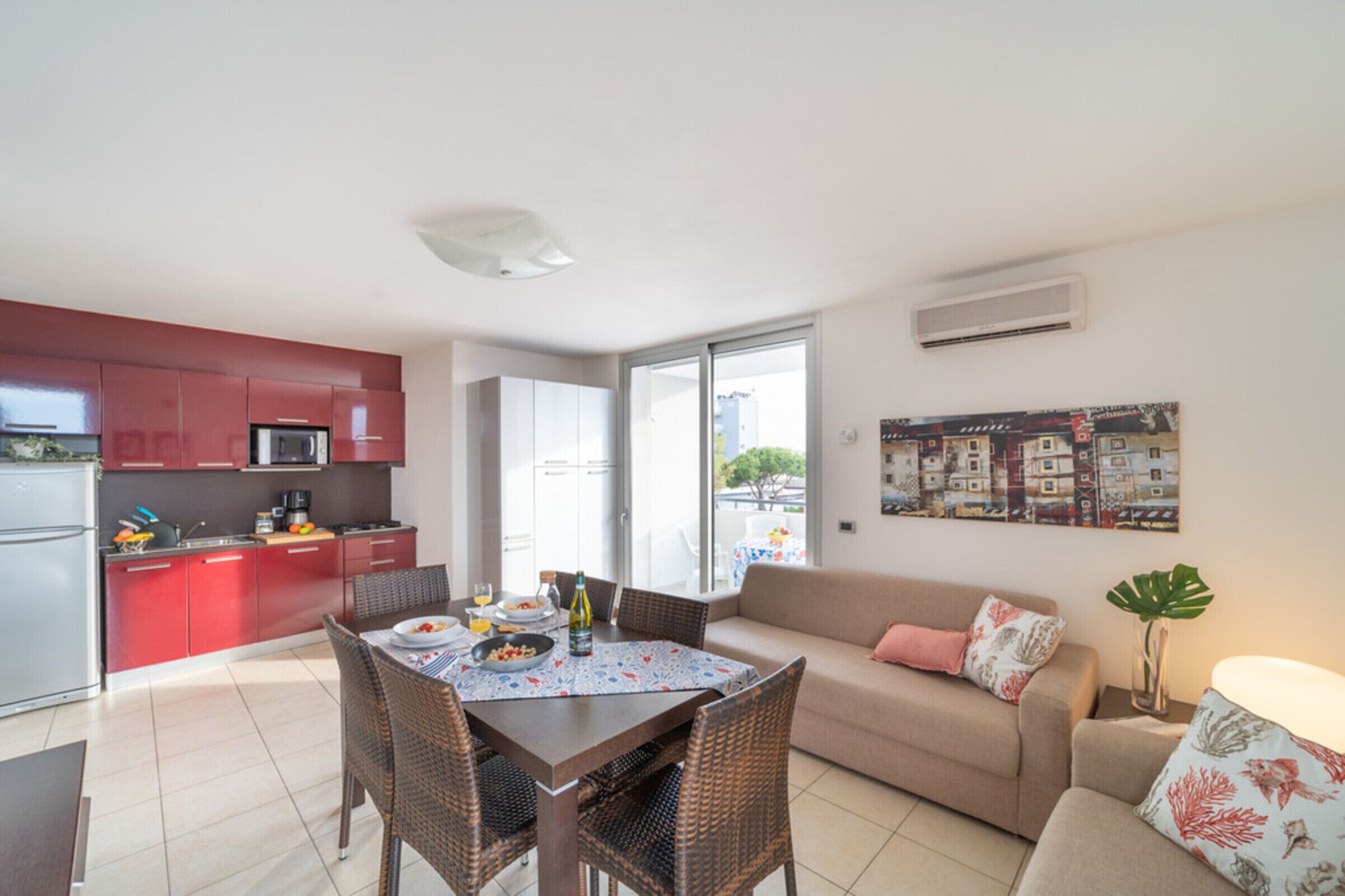 A modern apartment with a kitchen, dining area, and living room.