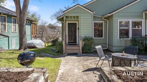 A house with a covered patio, a grill, and outdoor seating. - Modern Haven with King Suite + Impeccable Location (Austin)