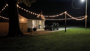 A house with a covered patio, a barbecue grill, and a car parked in front. - Minutes from Shorter University, Berry College, Tennis Center and Rome Area. (Armuchee)