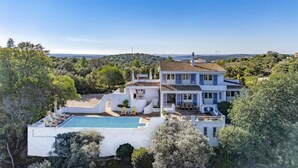 A large, multi-story house with a swimming pool, surrounded by lush greenery and hills. - Villa Quinta Marta Luisa by Villa Plus (Silves)