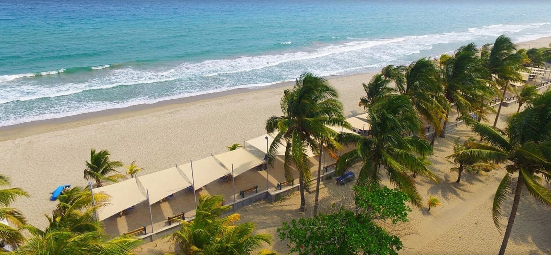 On the beach, white sand, sun loungers, beach towels