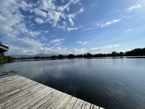 A calm lake with a wooden dock extending into the water.