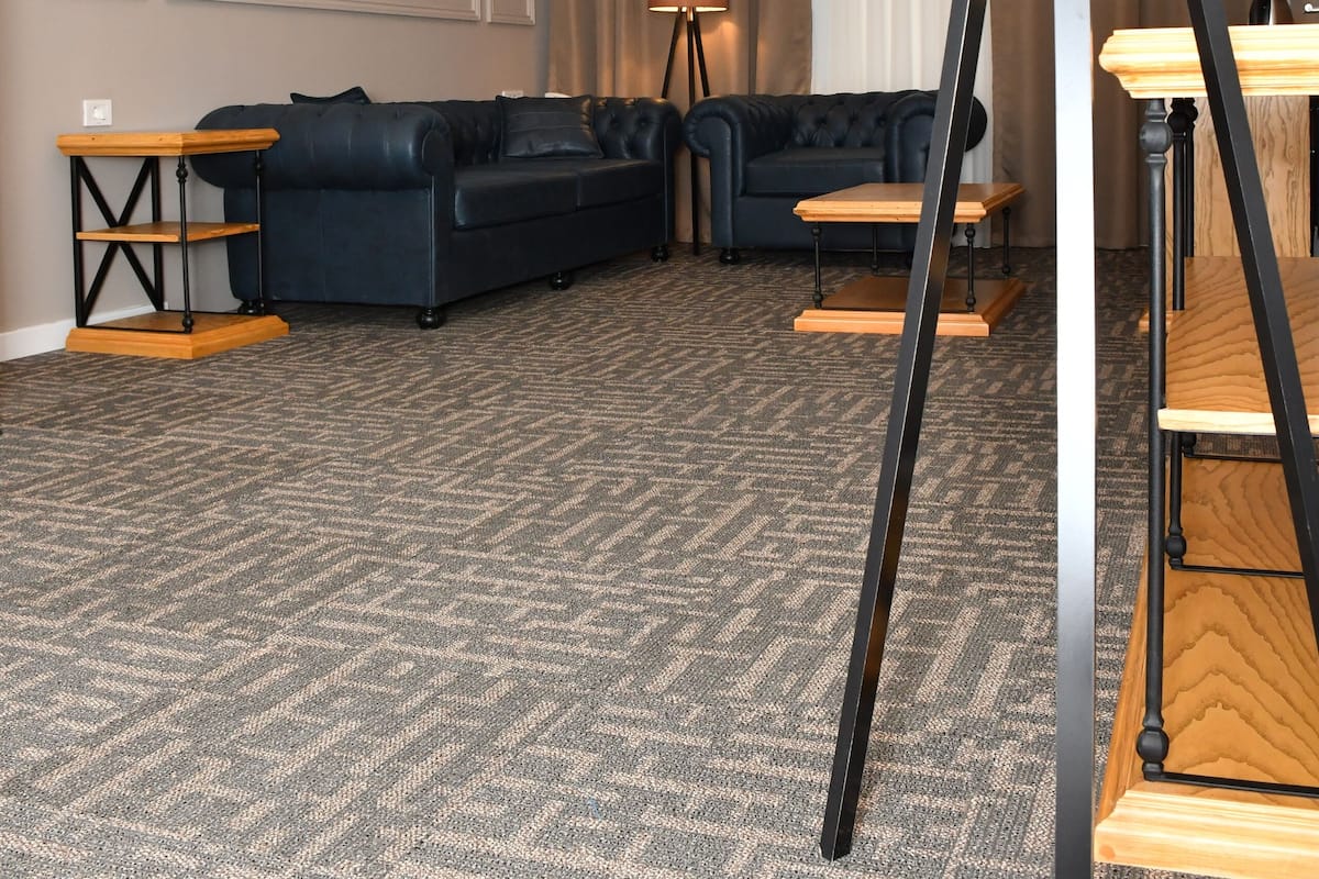 A modern living room with a dark sofa, a wooden coffee table, and a floor lamp.