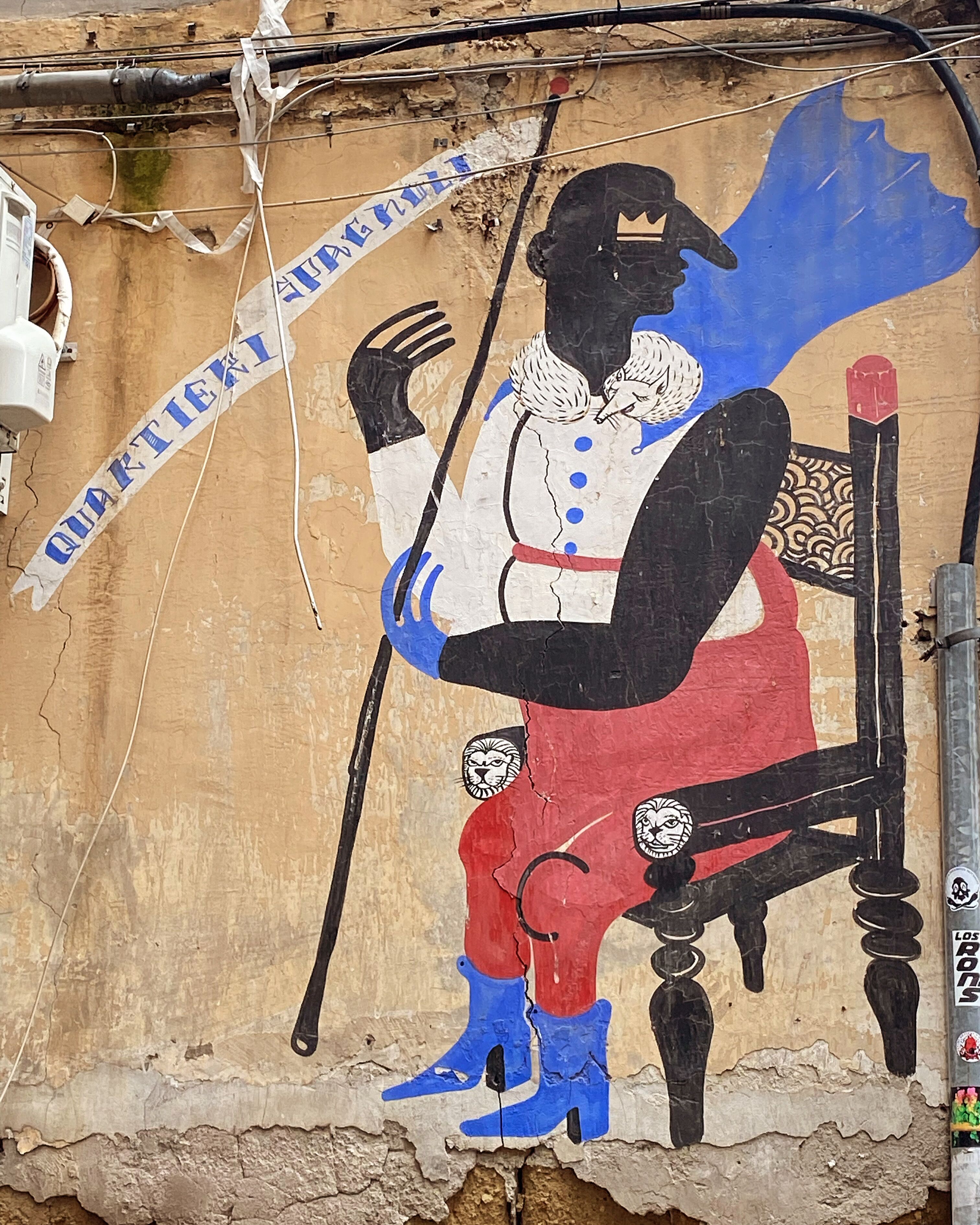 A mural with a figure in a chair, a banner reading "QUARTERLY," and a small figure in red.