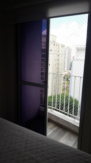Enjoy a peaceful retreat with a garden and city views from this balcony.