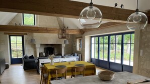 A spacious kitchen with a large island, wooden beams, and large windows. - Wunderschönes Landhaus Atemberaubende Aussicht (Huismes)