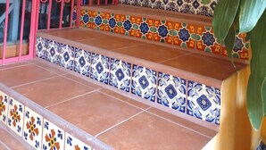 A staircase with colorful tiles and potted plants. - "Suite Serenity"- NEW Studio in PRIME location.10-minute walk to everything PV! (Puerto Vallarta)