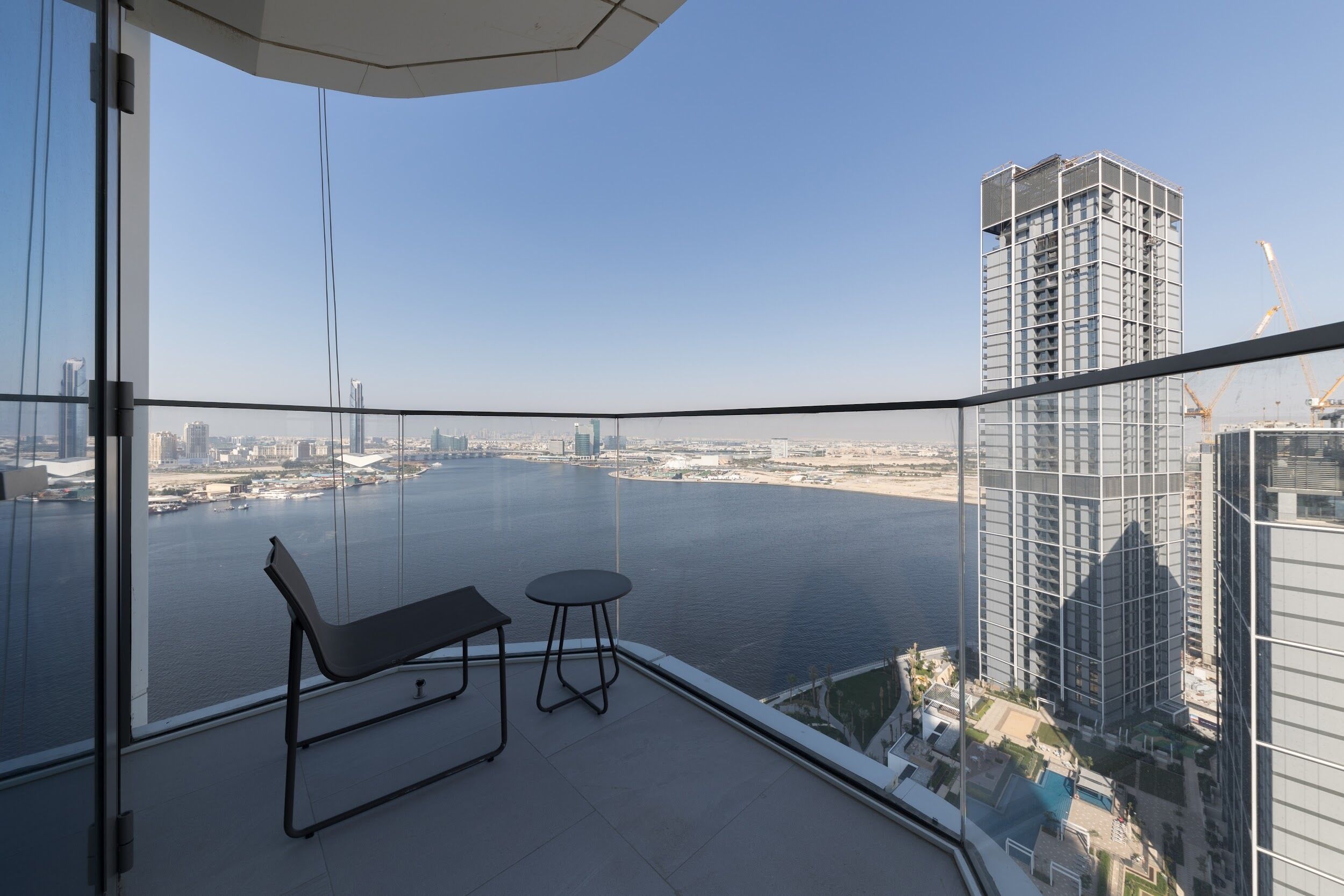 Ein Balkon mit Blick auf ein Gewässer und eine Stadtlandschaft.
