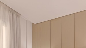 A hotel room with a large bed, wooden headboard, and a bedside lamp. - VESTA - New Cairo Residence (New Cairo)