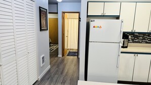 A kitchen with white cabinets, a refrigerator, and a microwave. - Charming 2-BHK Condo, nestled in the heart of picturesque Leavenworth. (Leavenworth)