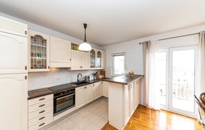 Enjoy cooking in this well-equipped kitchen with a central island, sink, stove, and ample storage.