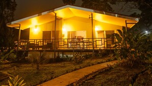 A modern house with a covered porch and a pathway leading to the entrance. - Secluded Tropical Home in La Fortuna (La Fortuna)