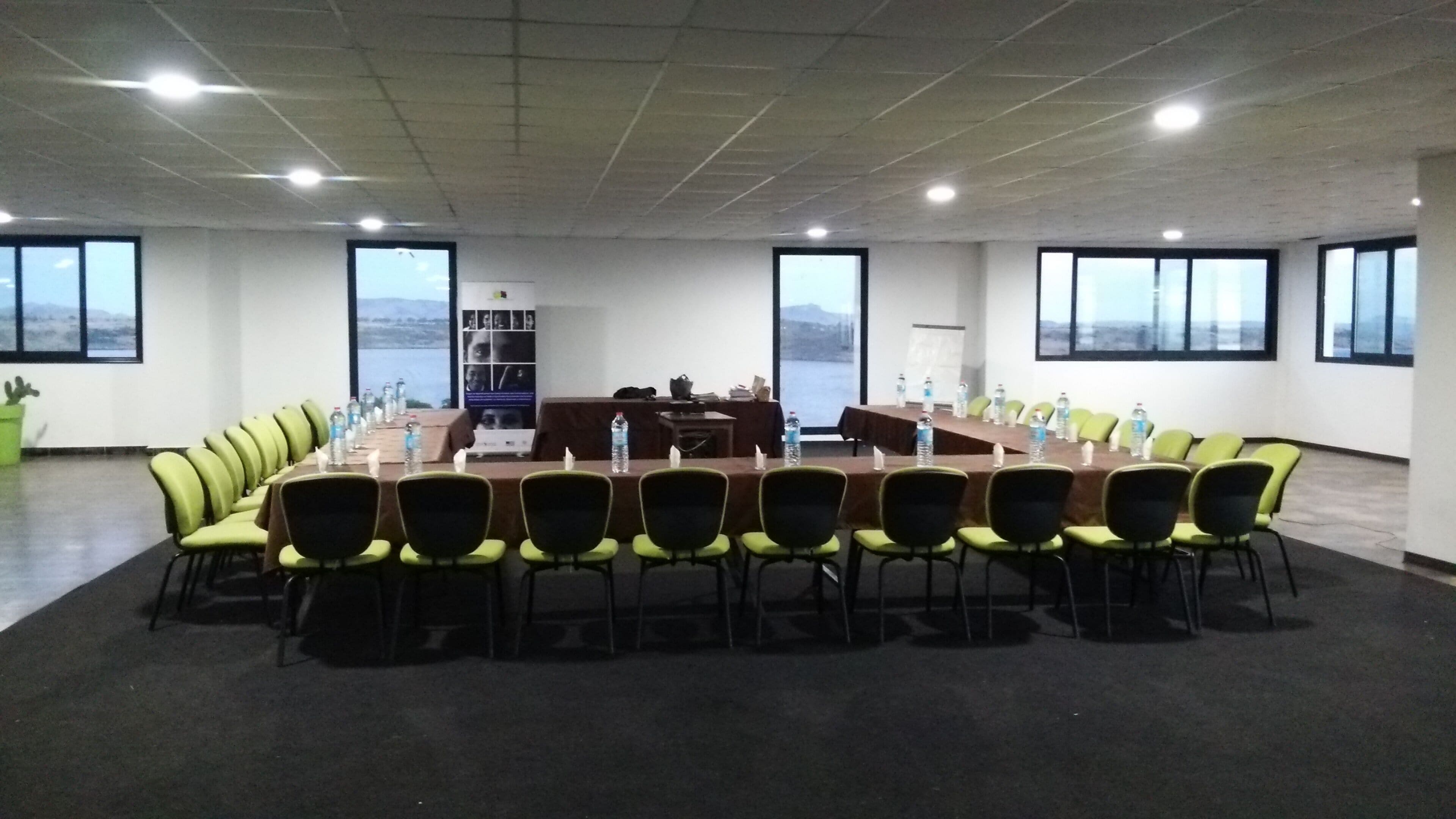 A conference room with a long table, chairs, and a whiteboard.