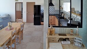Une cuisine moderne avec un réfrigérateur noir, des armoires en bois et un pare-feu en carreaux.