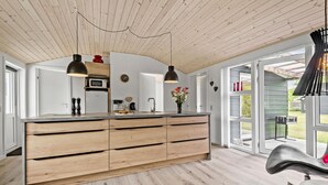 A modern kitchen with a wooden island, pendant lights, and a large window. - Awesome home in Tarm with WiFi (Tarm)