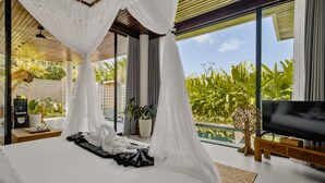 A modern bedroom with a large bed, a TV, and a balcony with plants. - Abhinaya Ubud Villa (Ubud)