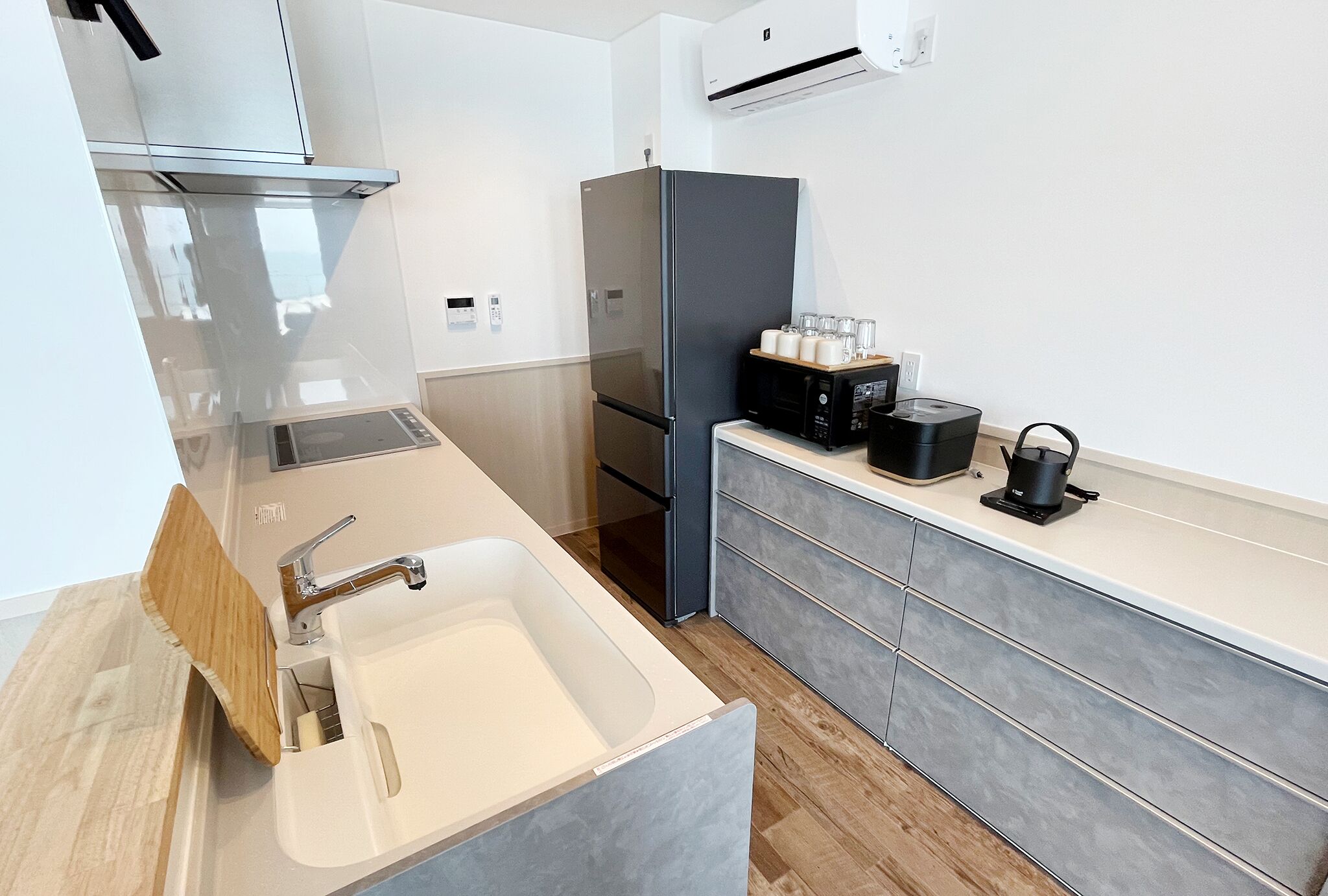 A modern kitchen with a built-in sink, stainless steel appliances, and a microwave.