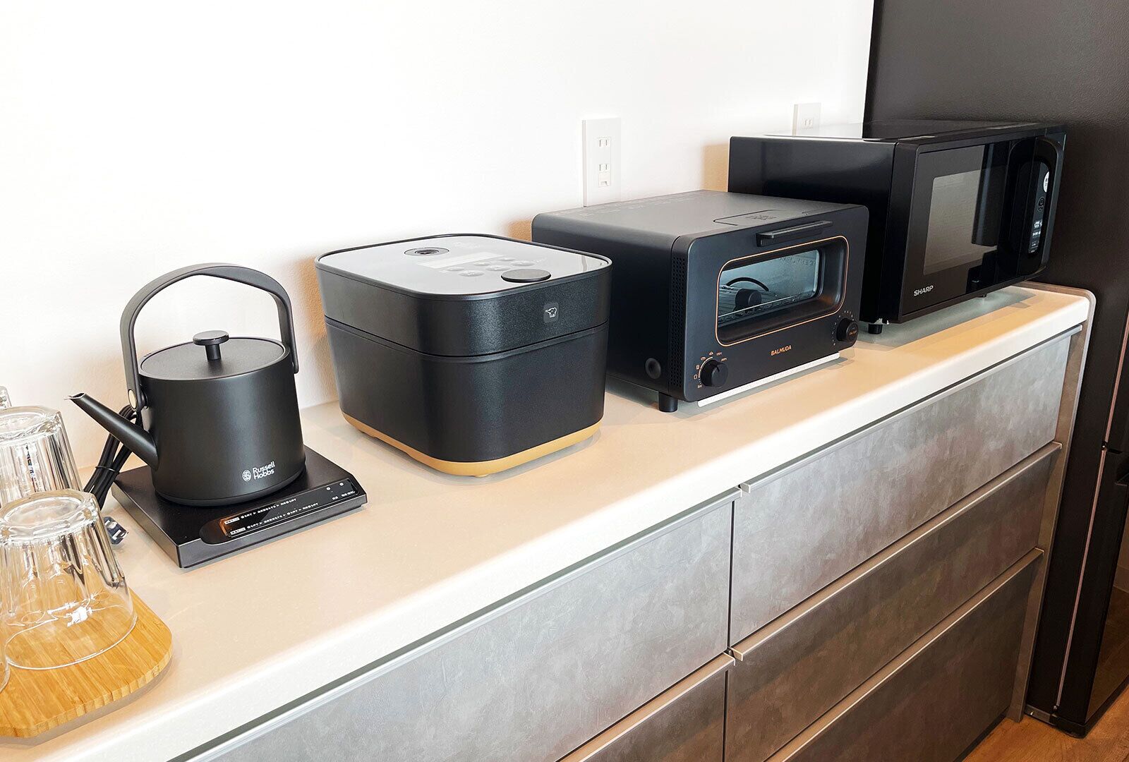A kitchen with a coffee maker, a microwave, and a toaster on the countertop.