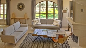 Una sala de estar con sofá, mesa de centro y chimenea.
