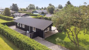 A modern house with a flat roof, a covered patio, and a well-maintained garden. - "Volmer" - 700m from the sea by Interhome (Hejls)