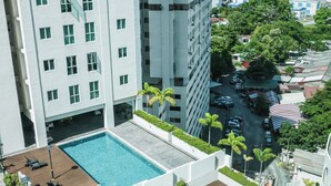 A high-rise building with multiple balconies and a swimming pool area. - Penang Straits Garden Georgetown (George Town)