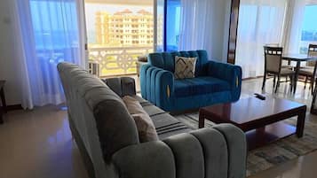Deluxe Apartment | Living area | 24-inch Smart TV with digital channels