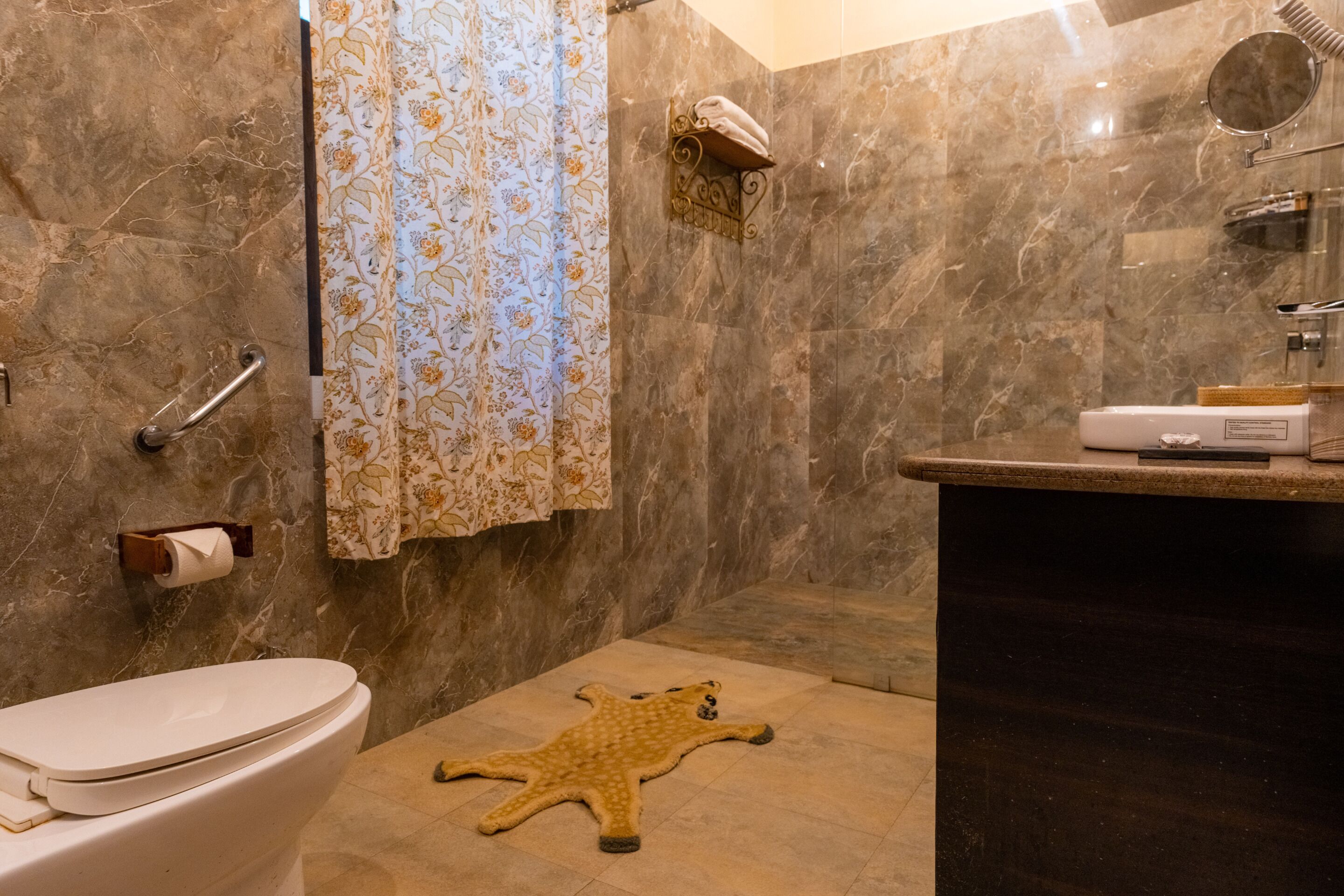 A bathroom with a toilet, a shower, and a sink.