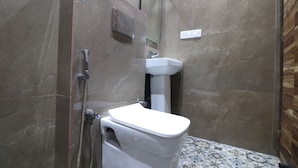 A bathroom with a toilet, shower, and sink. - Twamev Rajouri garden by The Arrow (New Delhi)