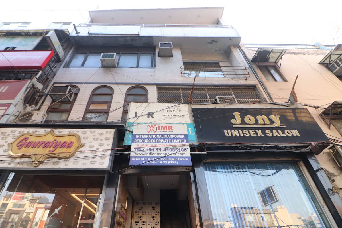 A building with multiple storefronts, including a salon named 'Jony Unisex Salon'.