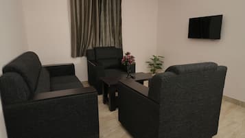Premium Apartment | Living area | Flat-screen TV
