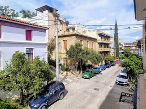 A narrow street lined with buildings, parked cars, and trees. - Acropolis Masterpiece Neoclassical Mansion (Athina)