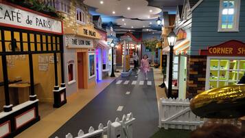 A model street with shops like 'The Palace' and 'Corner Shop'.