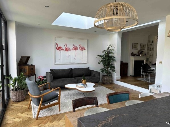 Relax in this inviting living space with a sofa, chair, and fireplace.