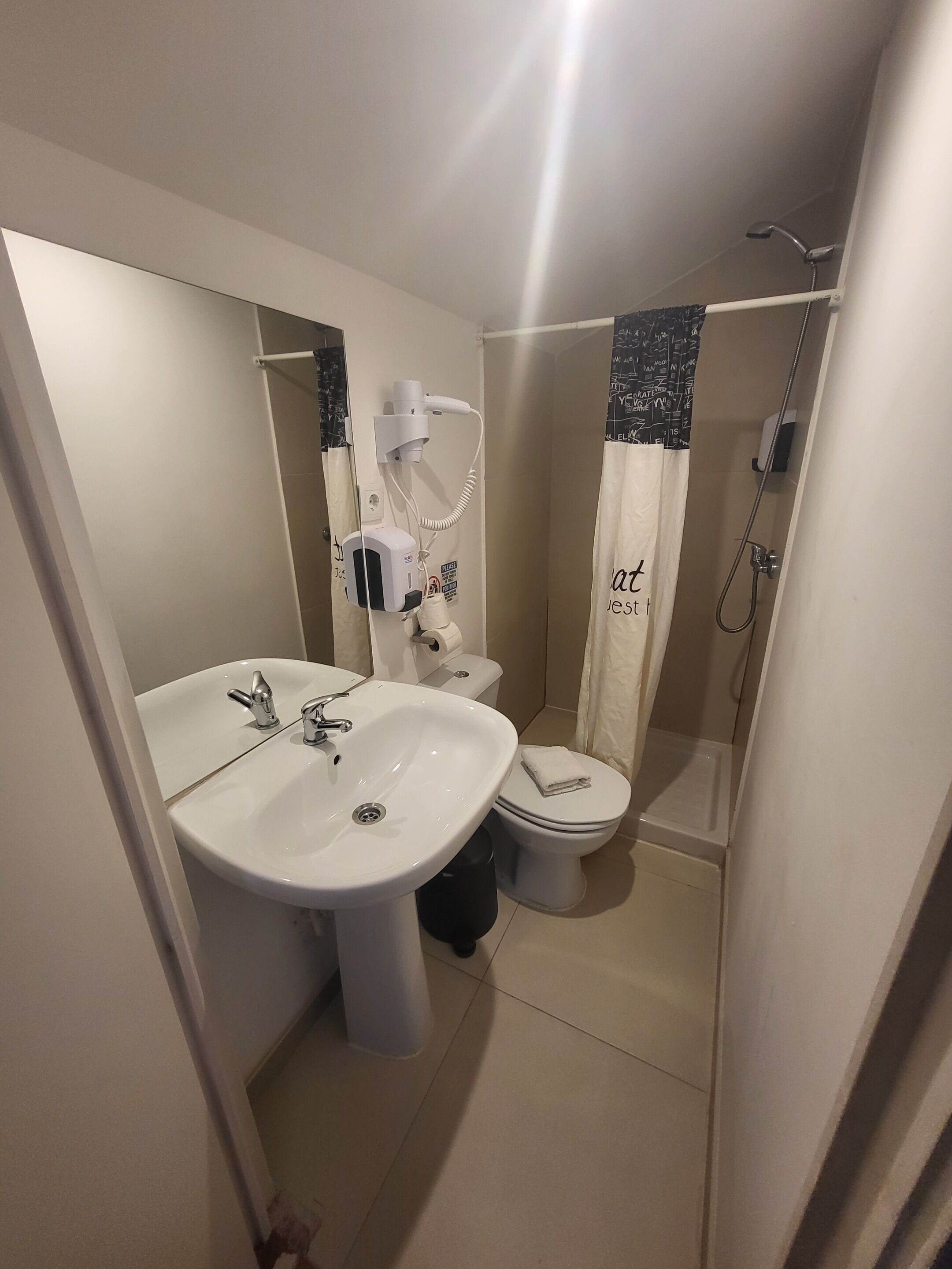 A bathroom with a sink, toilet, and shower.