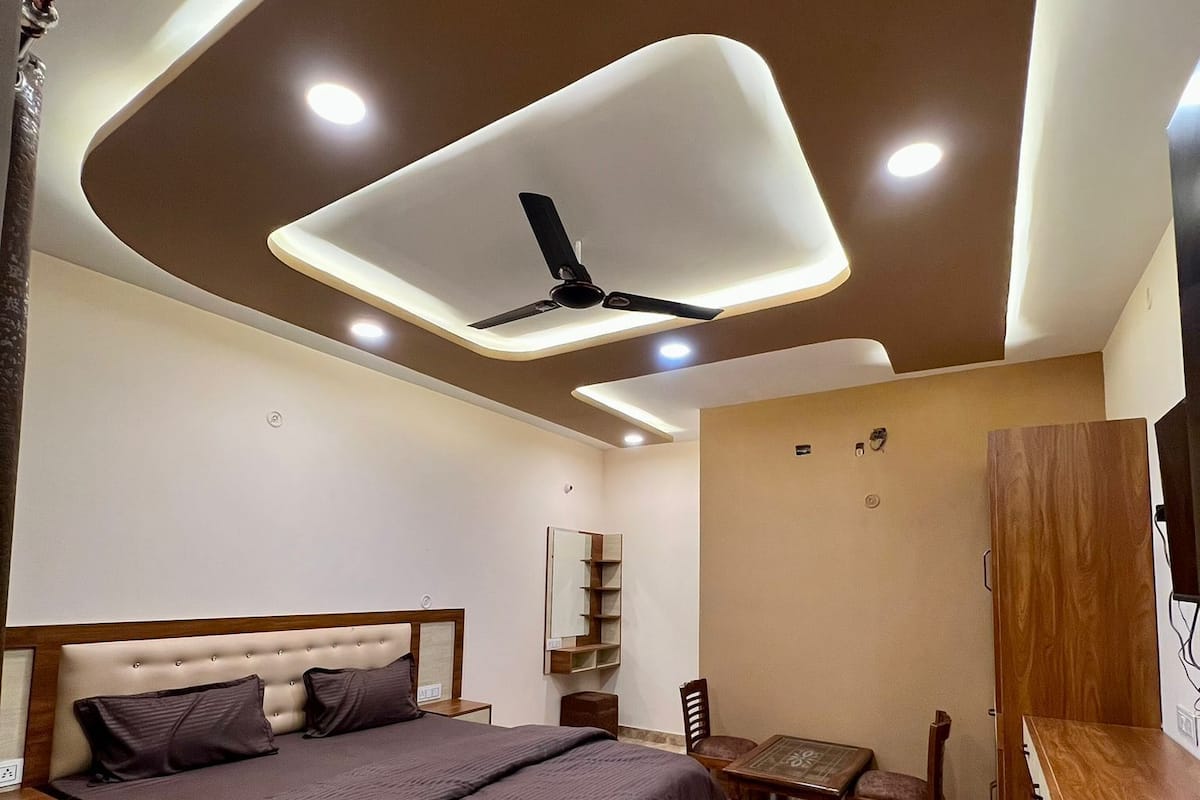 A modern bedroom with a bed, a desk, and a chair.